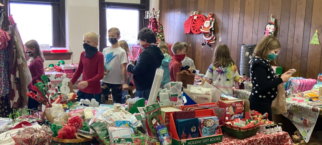 kids looking at tables full of stuff